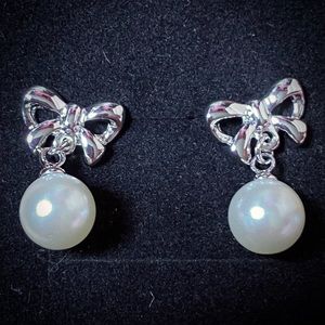 Silver bows and white pearl drop earrings